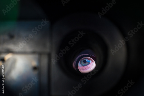 Man looking into a hole, look through something, peeping man