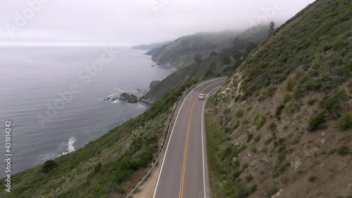 Wallpaper Mural Aerial Panning Shot Of Vehicles On Winding Coastal Road By Sea, Drone Flying Forward Over Mountains Against Sky - Big Sur, California Torontodigital.ca