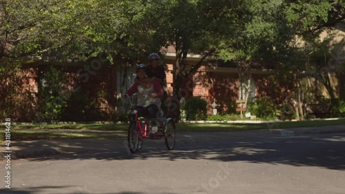 Wallpaper Mural Cute couple in residential suburb riding on tricycle together, wearing helmet Torontodigital.ca