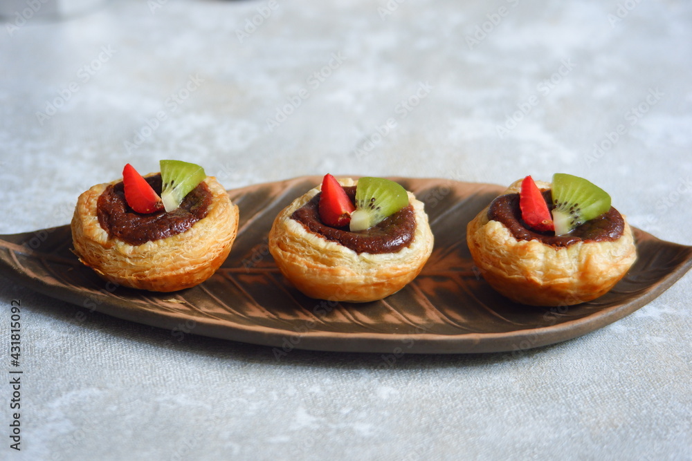 chocolate egg tart with fruits in a plate