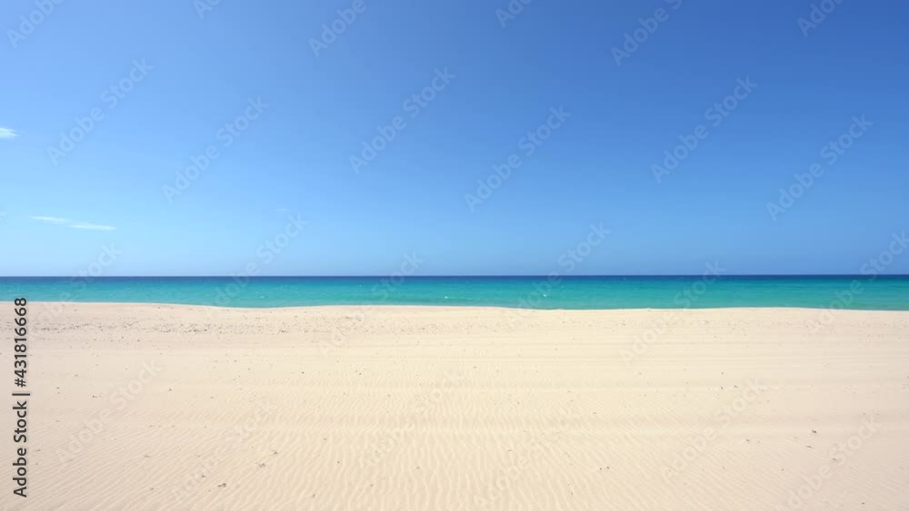 Minimalistic tropical background. Empty sandy beach with turquoise water and clear blue sky on the horizon. Beautiful natural landscape Minimalistic tropical background. Empty sandy beach with turquoise water and clear blue sky on the horizon. Beautiful natural landscape
