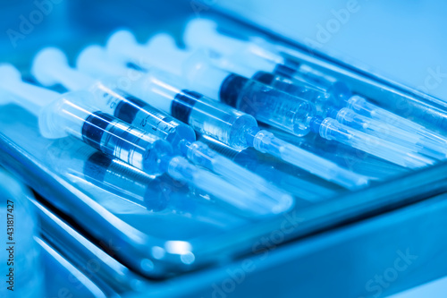 Close up photo of corona vaccine syringe with blur background. Drug prepare for immunization againt covid 19 pandemic.Selective focus at medicine syringe.Medical concept.