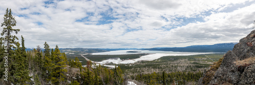 Stunning landscape from McClintock Ridge in northern Canada, Yukon Territory during spring time. Scenic, stunning, vast view in sub arctic area of North America. Pine tree, boreal forest, frozen lakes photo