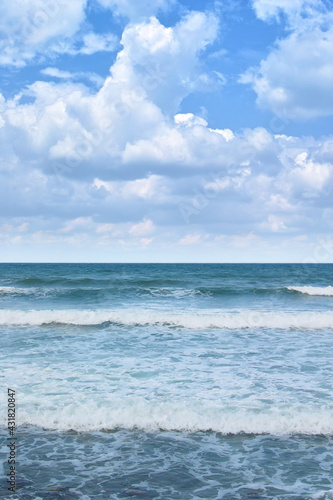 海 積乱雲と波寄せる夏のビーチ