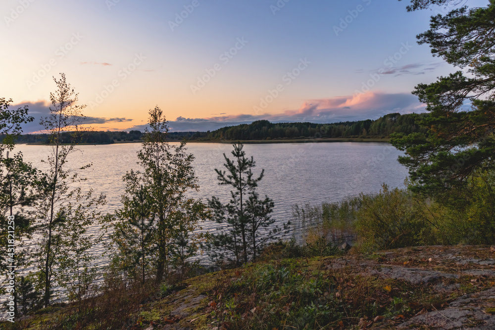 Sunset on a lake with rocky shores in Karelia