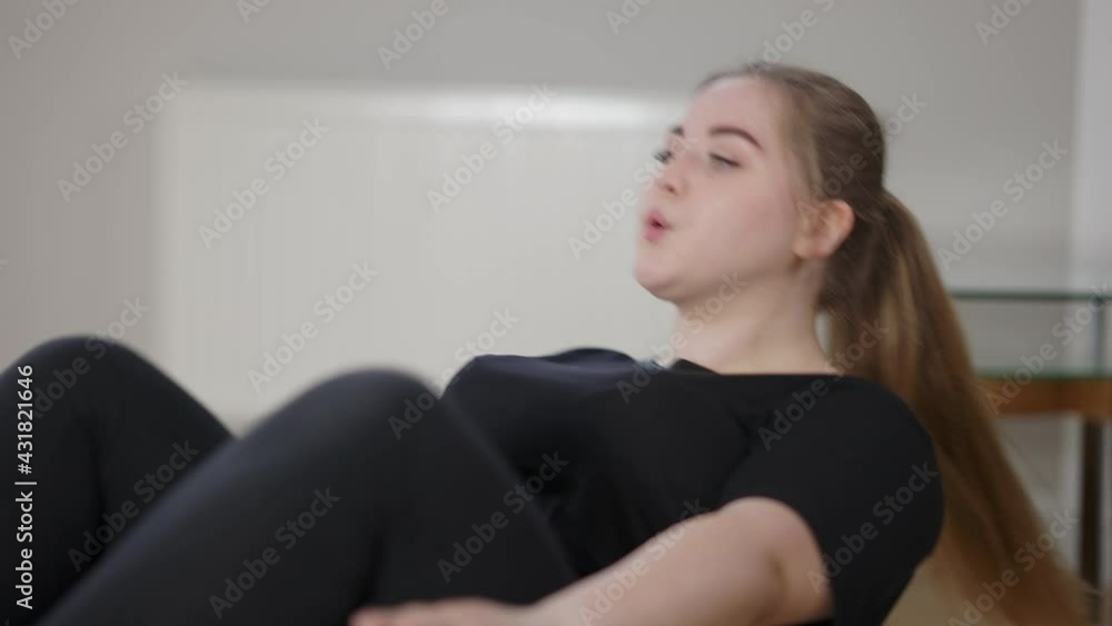 Endurant overweight Caucasian woman doing pumping press at home. Portrait of plus-size sportswoman exercising indoors. Body positive and self improvement concept Endurant overweight Caucasian woman doing pumping press at home. Portrait of plus-size sportswoman exercising indoors. Body positive and self improvement concept
