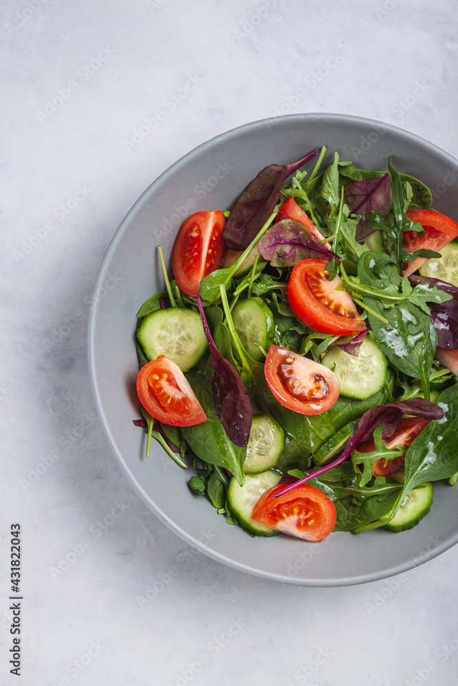 Healthy fresh salad of vegetable cucumber, tomato, spinach, arugula Healthy fresh salad of vegetable cucumber, tomato, spinach, arugula