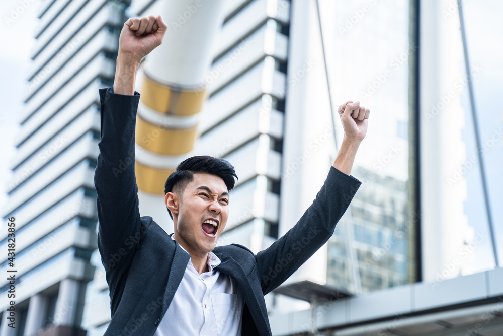 Asian young business man feeling happy and cheerful with new project. Asian young business man feeling happy and cheerful with new project.