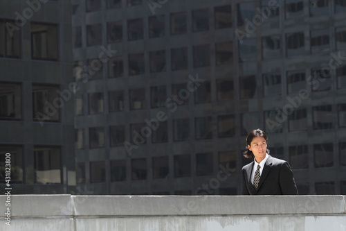 Young Japanese businessman walking in the american business district 