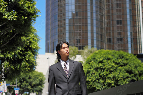 Young Japanese businessman walking in the american business district	
