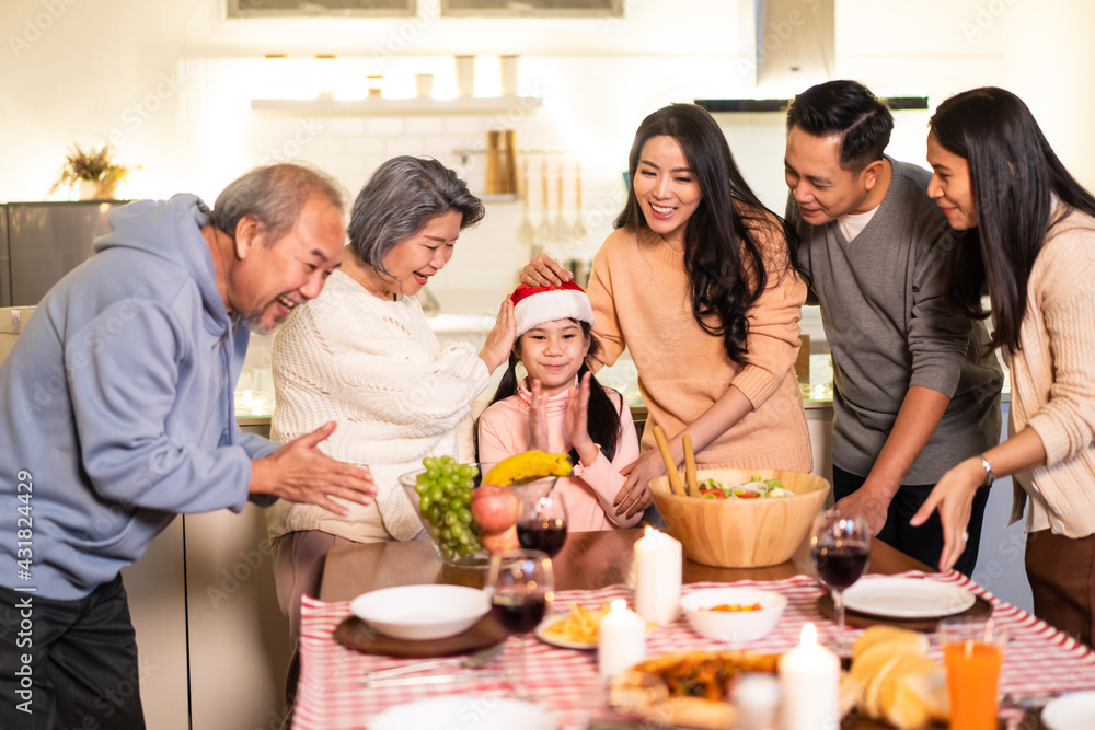 Asian big family sing a song while preparing foods for Christmas party Asian big family sing a song while preparing foods for Christmas party