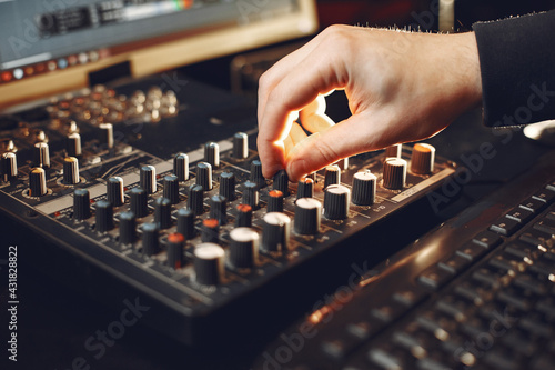 Man working in a studio with a sound recording equipment © hetmanstock2
