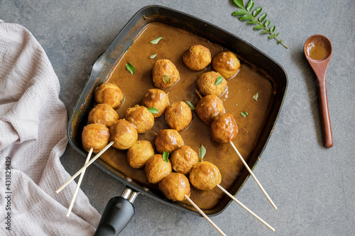 Delicious homemade popular Hong kong street food / Hong Kong Curry Fishball / Made from fresh Spanish Mackerel fish paste, formed into round fishball, deep fried, cooked in thick curry gravy photo