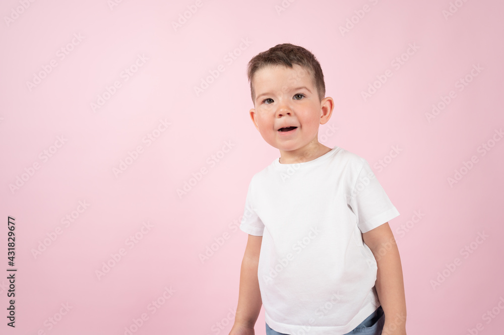 Surprised boy in white t-shirt with the open mouth, close up portrait on pink background. Discounts and sales concept Surprised boy in white t-shirt with the open mouth, close up portrait on pink background. Discounts and sales concept
