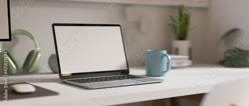 3D rendering, simple workspace with laptop, mug, headphone and plant pot © bongkarn