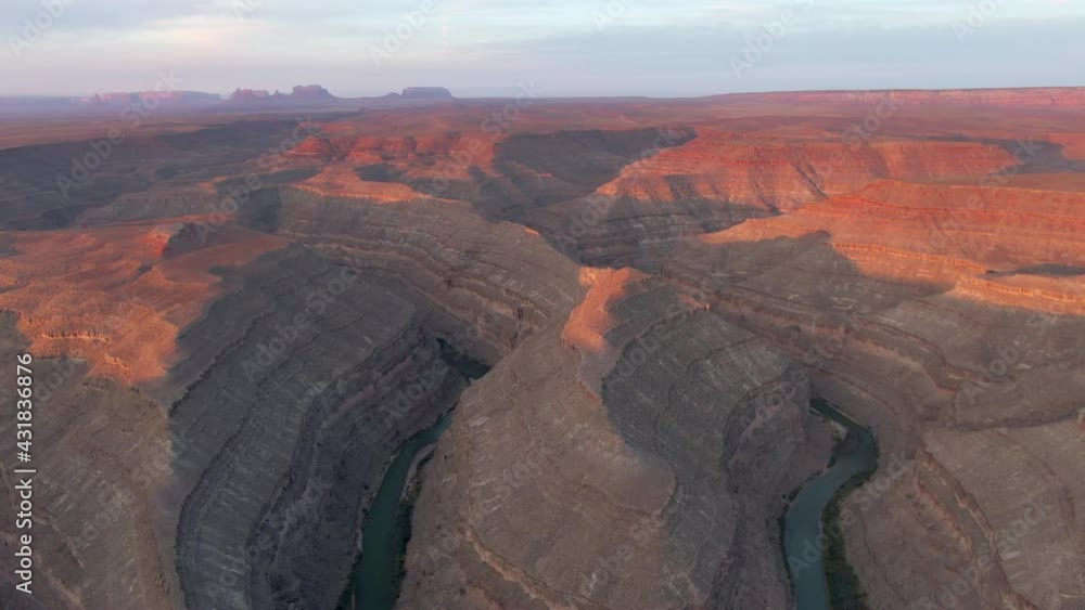 Aerial Shot Of Rocky Landscape With Canyon Against Sky, Drone Ascending Backward Over Famous Landmark At Sunset - Goosenecks State Park, Utah Aerial Shot Of Rocky Landscape With Canyon Against Sky, Drone Ascending Backward Over Famous Landmark At Sunset - Goosenecks State Park, Utah