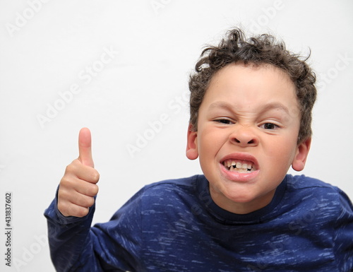 boy with thumbs up gesture on white background stock photo