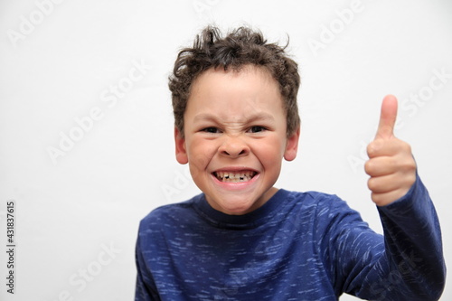 boy with thumbs up gesture on white background stock photo