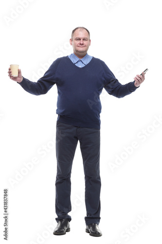 Mature man with a smartphone and a takeaway coffee.