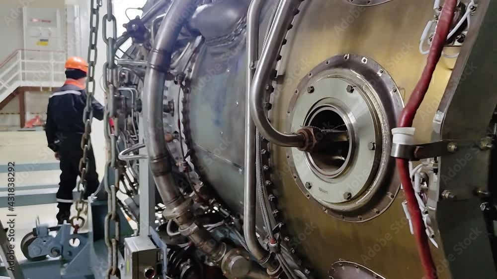 The mechanic is servicing the aircraft engine. Jet engine nozzle. Fuel ...