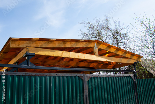 Carport made of planks and polycarbonate.