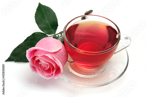 mug with tea and a pink rose on a white background
