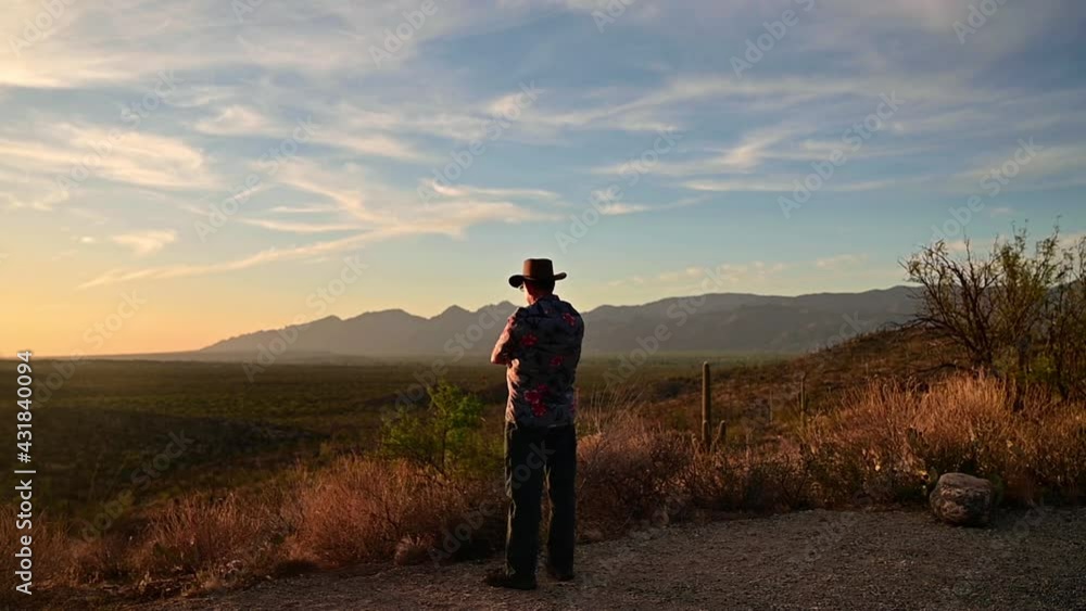 Man admires sunset at Saguaro National Park, Tucson, Arizona. Gimbal, slow pan left Man admires sunset at Saguaro National Park, Tucson, Arizona. Gimbal, slow pan left