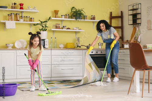 Mother and daughter mopping...