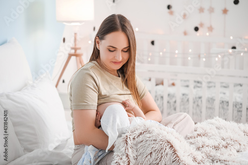 Young woman breastfeeding h...