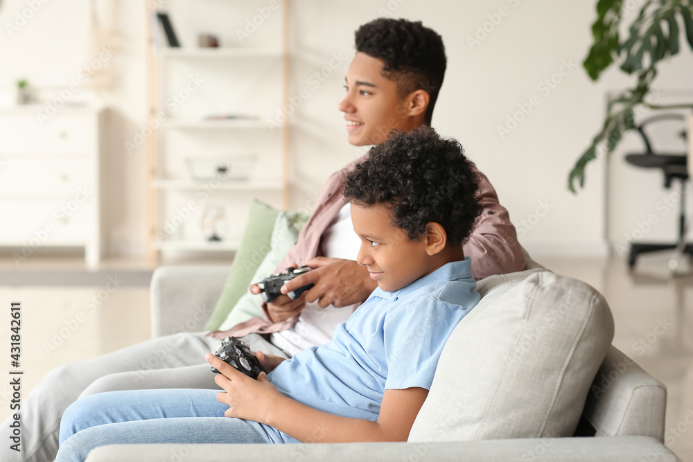 African-American boys playing video game at home African-American boys playing video game at home