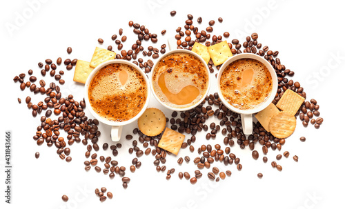 Cups of tasty coffee and crackers on white background © Pixel-Shot