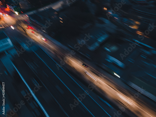Fototapeta Car driving high speed in city at night