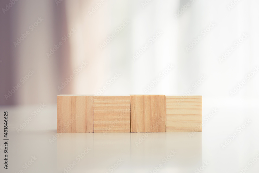 Four blank wooden block cubes on the table with blurred background for mockup, template, banner concepts