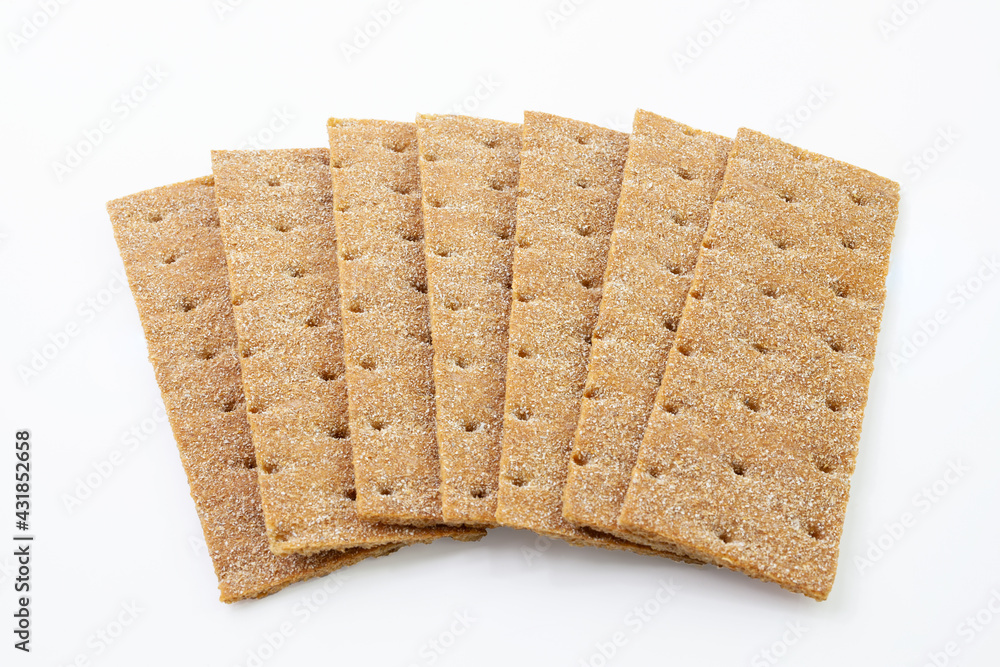 Heap of thin, crispy wholegrain rye breads isolated on white background.