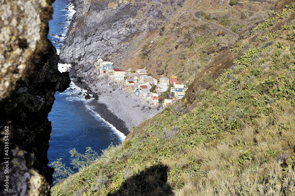 view from the cliff of a small fishing village on the beach in Madeira