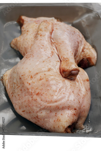 Two raw duck legs on a grey plastic tray vacuumed packed for freshness. Fresh poultry product, meat industry business