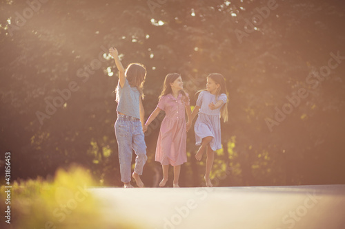  Time for fun. Three little girls in nature together.