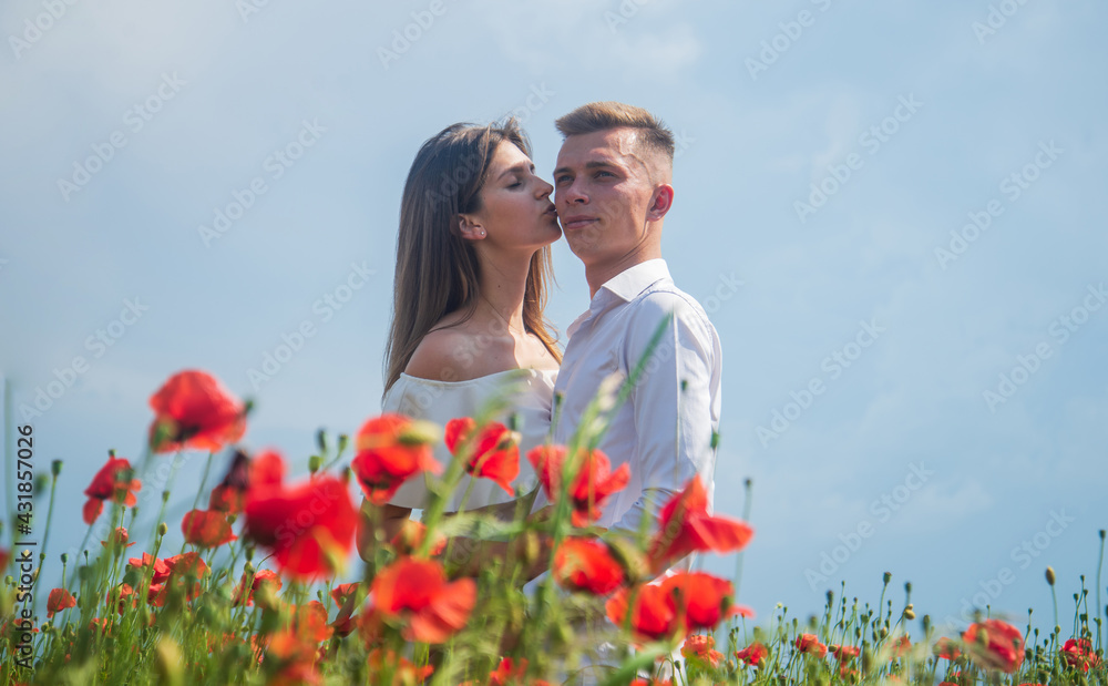 Happy couple in love kissing in beautiful field of poppy flower on romantic day, love Happy couple in love kissing in beautiful field of poppy flower on romantic day, love