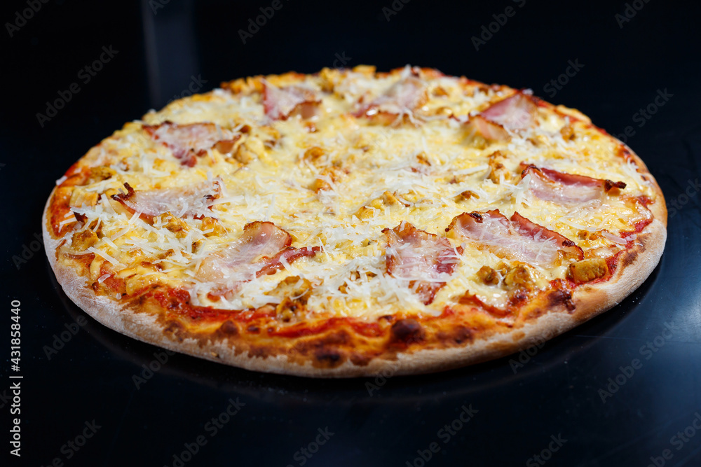 Chicken breasts with creamy sauce and grated cheese on a pizza. tasty fresh pizza on a thick crust with meat