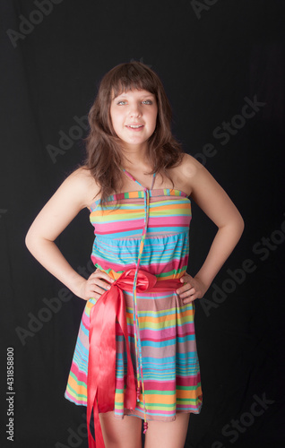 girl in a bright dress on a black background
