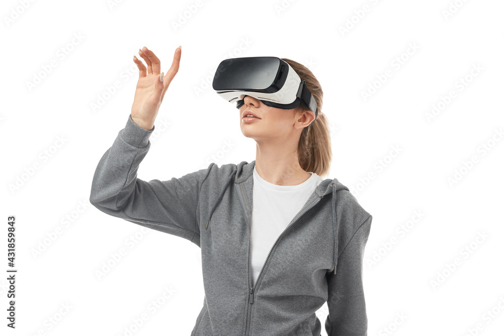 Woman in VR headset touching air Woman in VR headset touching air