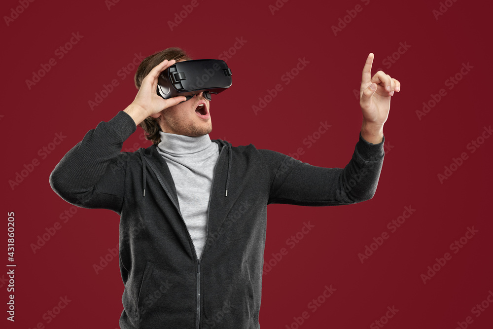 Amazed man in VR headset exploring virtual reality Amazed man in VR headset exploring virtual reality