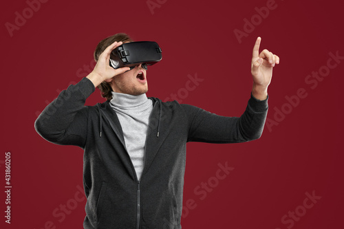 Amazed man in VR headset exploring virtual reality © kegfire