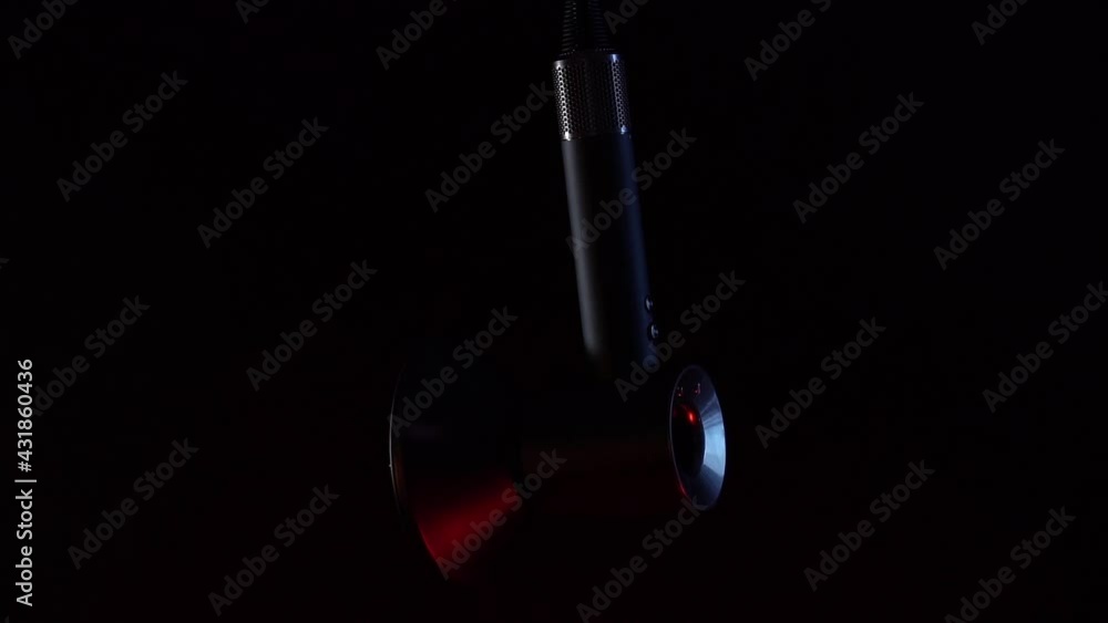 Grey electrical hand-held hair dryer for hair salon or barber shop on black background with fire balls. Fire illuminates contours of hair dryer. Epic shots are suitable for commercial advertising Grey electrical hand-held hair dryer for hair salon or barber shop on black background with fire balls. Fire illuminates contours of hair dryer. Epic shots are suitable for commercial advertising