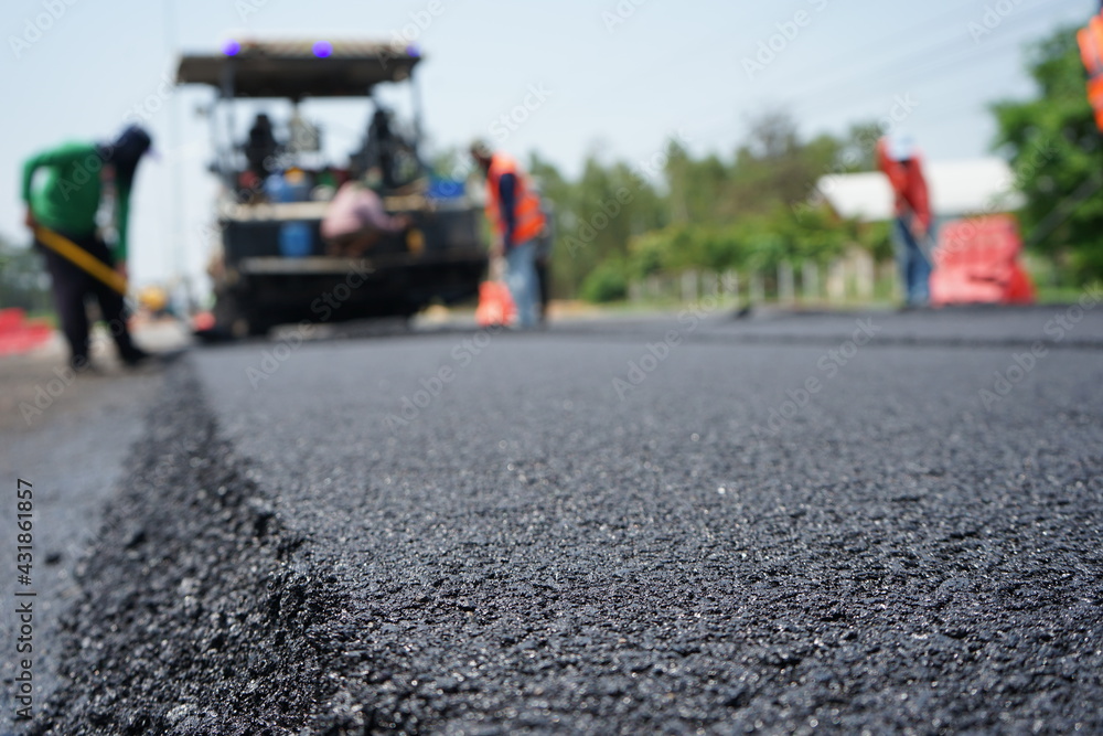 The image is blurred in the construction of asphalt road.