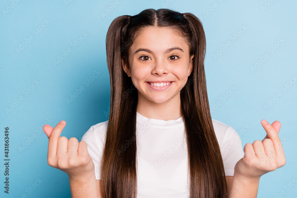 Portrait of attractive cheerful long-haired girl showing korean love sign isolated over bright blue color background Portrait of attractive cheerful long-haired girl showing korean love sign isolated over bright blue color background