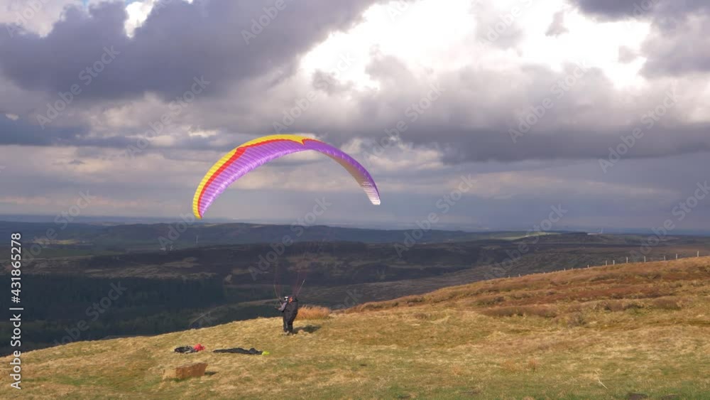 Paragliding pilot on high landscape waiting take off