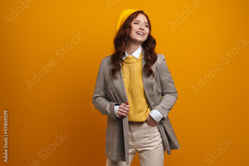 Happy young woman with long red hair in sweater