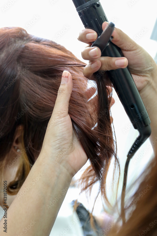 Fototapeta premium Woman's hair being coloring or painted at the hair stylist beauty salon