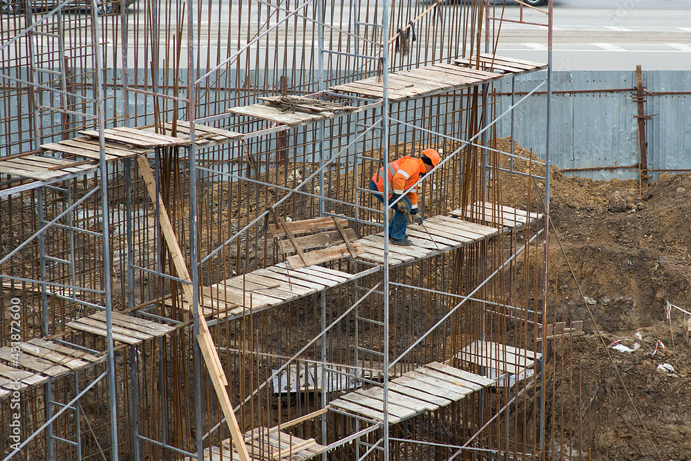 Fototapeta premium A worker makes a reinforced bridge wall structure.